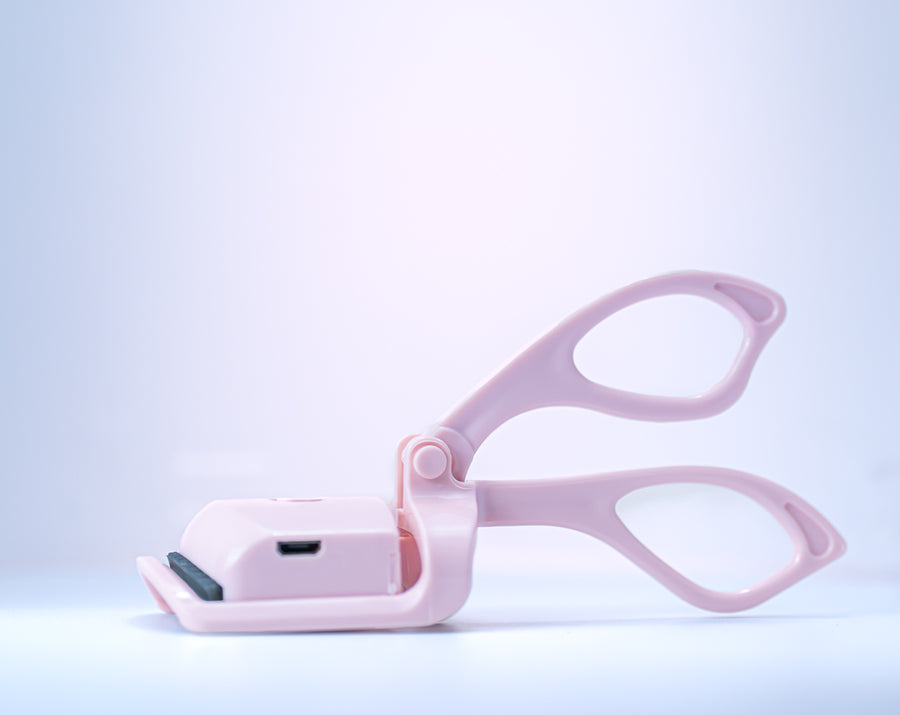Pink pet grooming tool on a light blue background