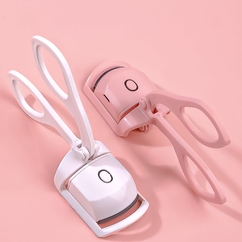 Pair of white and pink pet nail clippers on a pink background