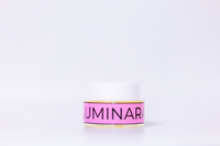 Pink and gold container with 'Luminara' branding on a white background