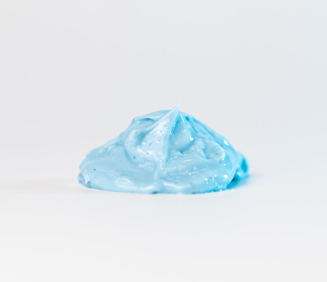 Blue face lotion on a white background